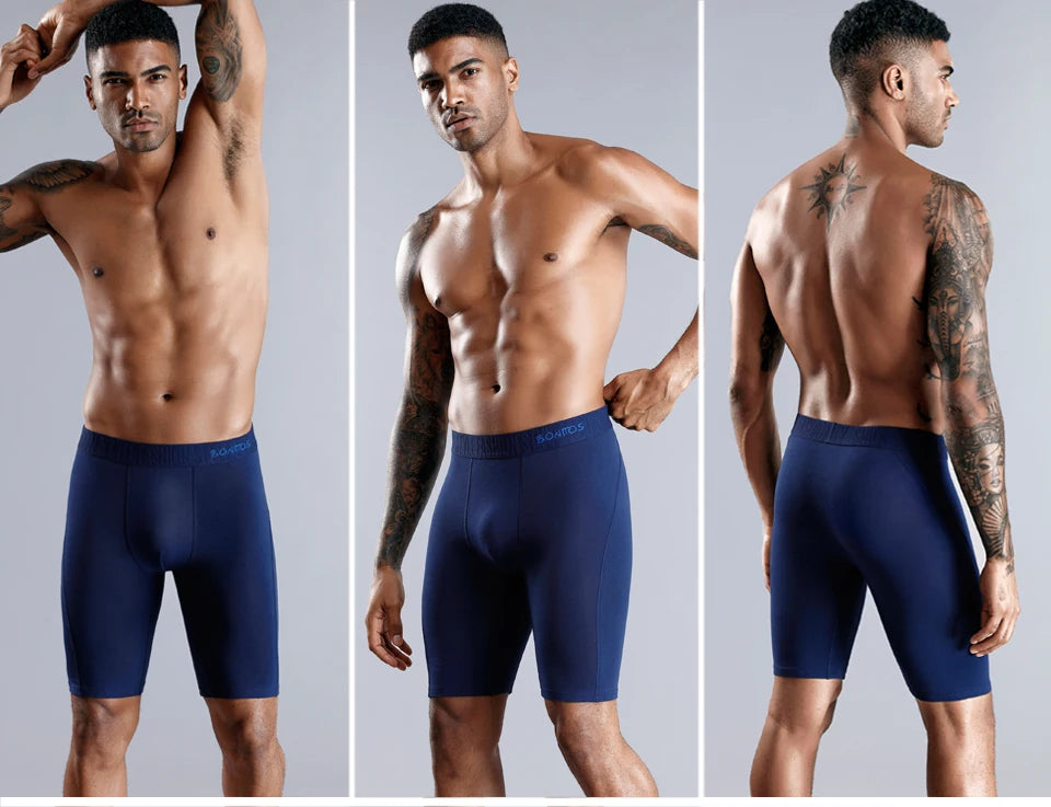 Men's blue long boxer briefs with elastic waistband and stitched front seam.