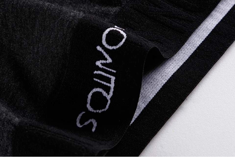 Black long boxer briefs fabric close-up with stitched logo on waistband area.