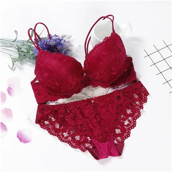 Red/burgundy underwired push-up lace bra set with matching lace panties, laid flat