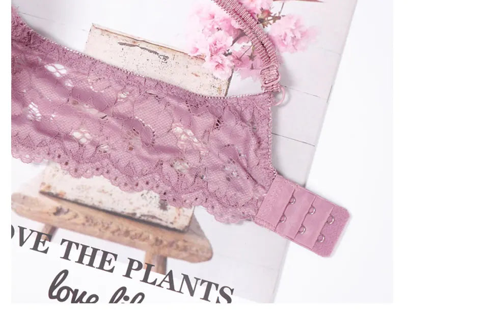 Pink lace thong-style panty with lace waistband and hook-and-eye strap detail