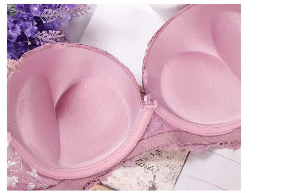 Pink underwired push-up bra close-up showing smooth cup and lace trim