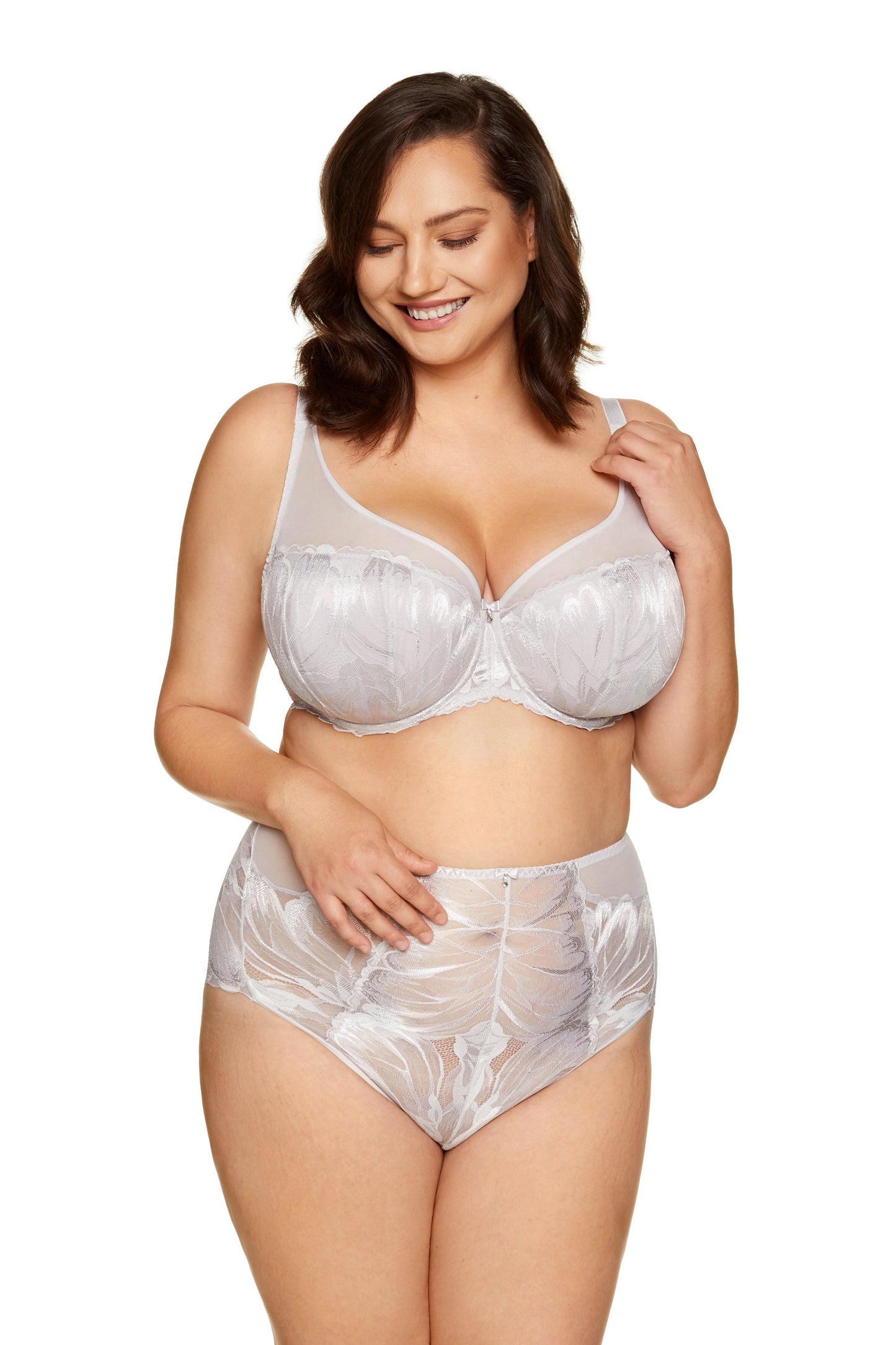 White lace high-waist brief on model, featuring scalloped edges and floral embroidery