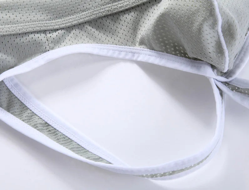 Low-rise hip-lift thong light gray front with white-trimmed cutout opening