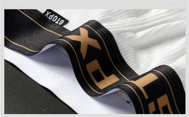 White U-pouch boxer waistband with black logo band and gold lettering, close-up view.