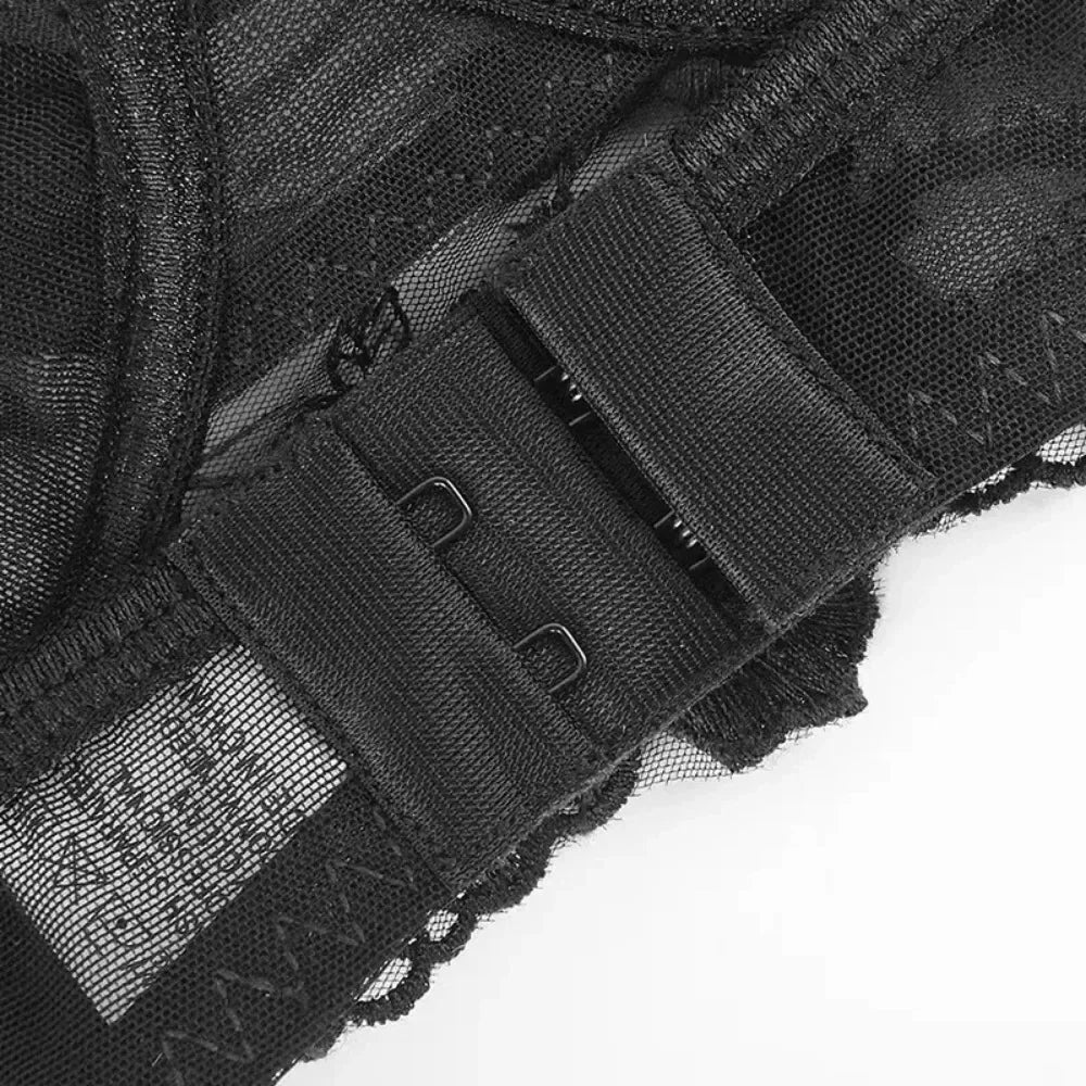 Black lace close-up of hook-and-eye closures with sheer mesh trim