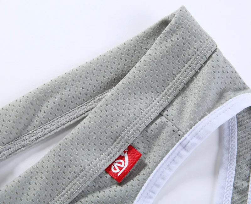 Low-rise hip-lift thong light gray waistband with white stitching and brand label tag