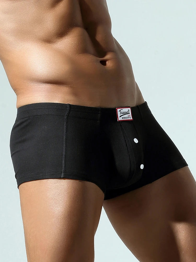 Black front view brief with pouch and two-button fly placket under logo patch.