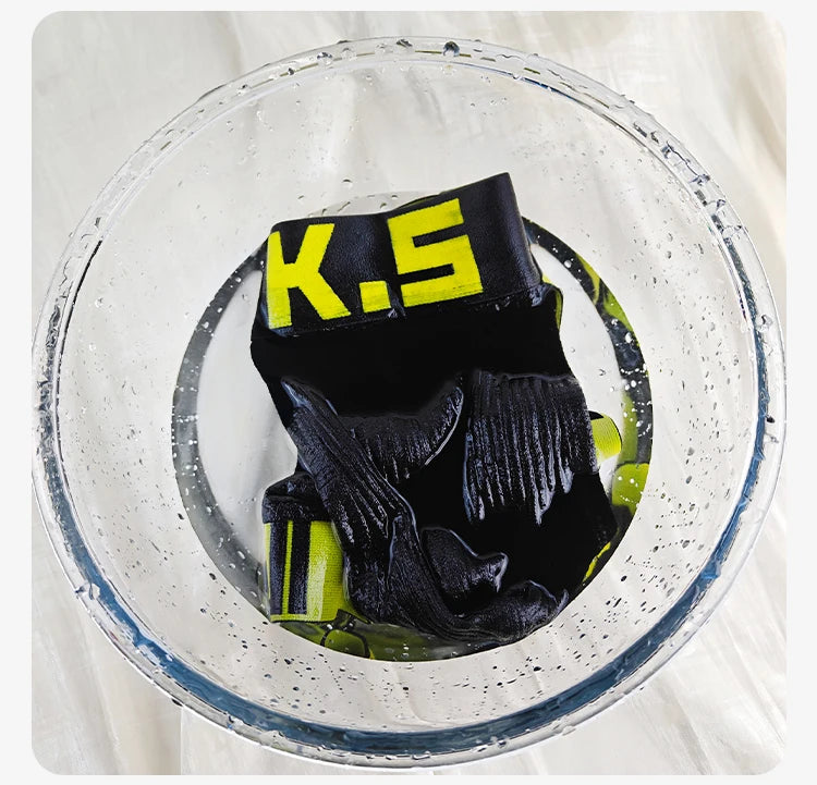 Black stretch brief in water with neon yellow logo elastic waistband.