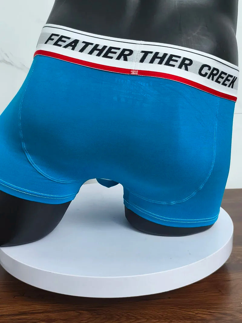 Blue sports boxer shorts with wide logo waistband and white contrast seam details