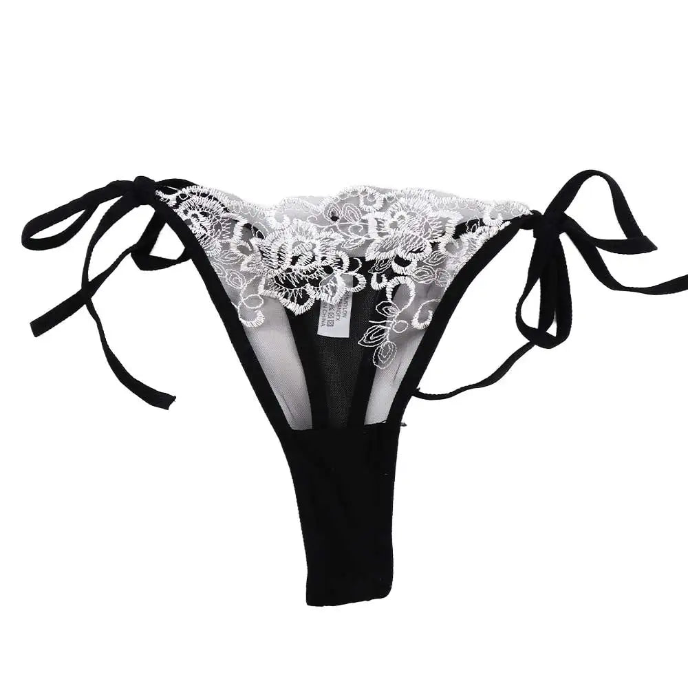 Embroidered lace panty brief in white lace over black with sheer sides and tie bows