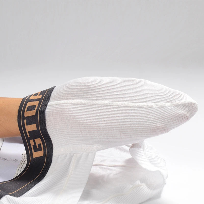 White modal wicking U-pouch boxer briefs on a leg, waistband and pouch seam visible.