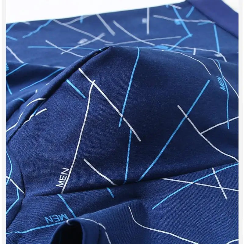 Folded dark blue stretch trunks with white and light-blue abstract line pattern
