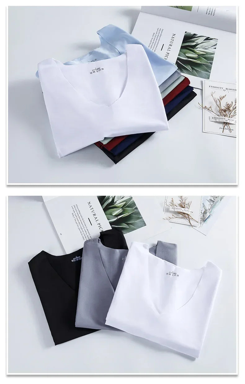 Folded men's ice silk traceless tank tops in white, light blue, black, and gray