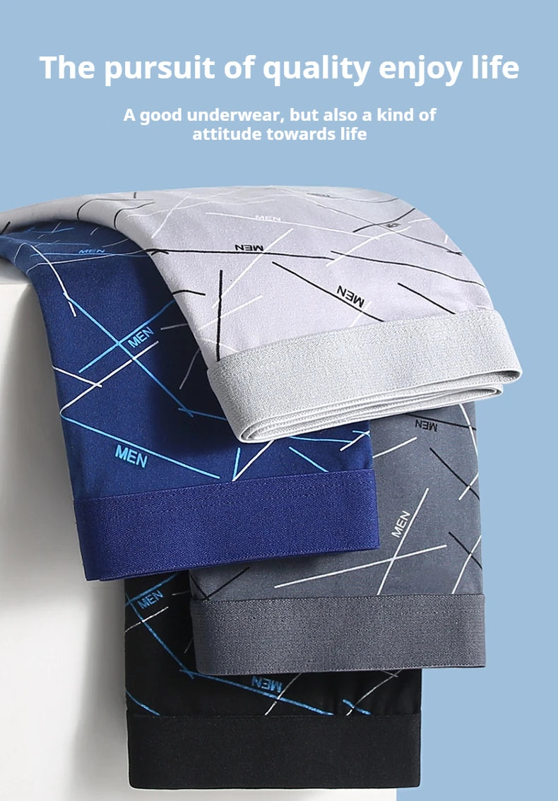 Stacked men’s stretch trunks in dark blue, light gray, and black with line patterns
