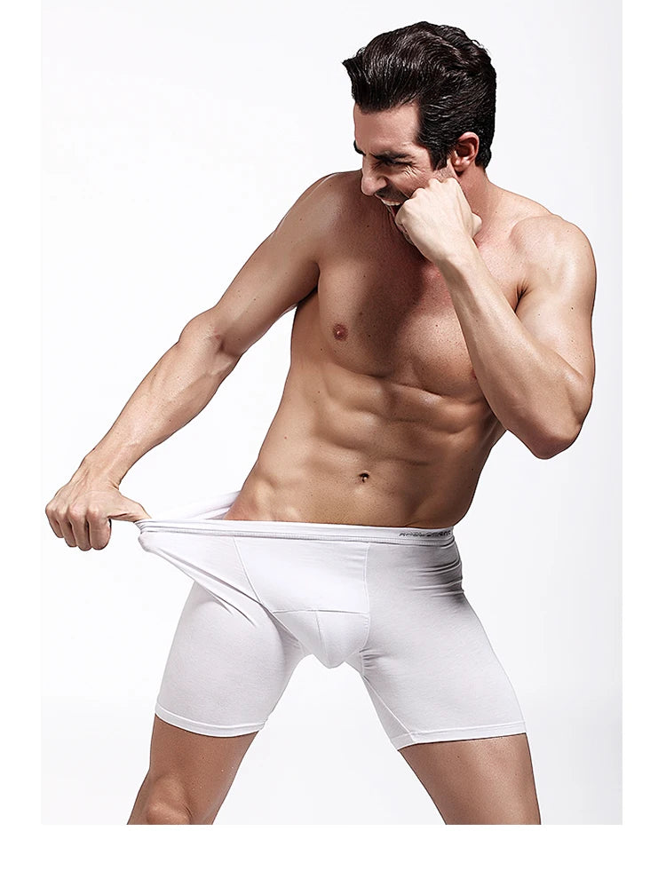 White compression boxer briefs on model, mid-thigh length with elastic waistband