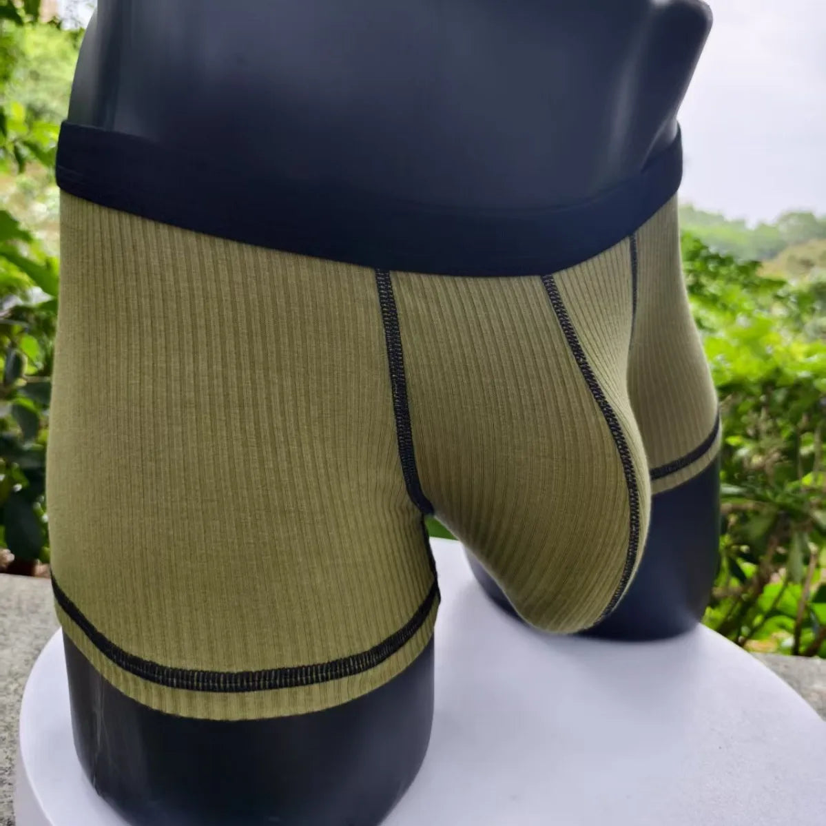 Olive ribbed boxer shorts with wide black waistband and contrast trim, large front pouch