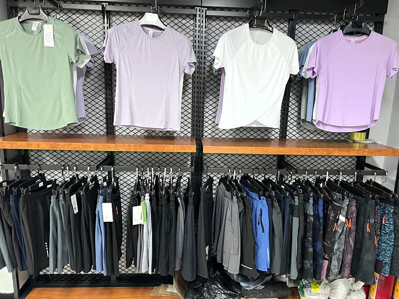 Assorted men's breathable mesh gym vest tanks on hangers: mint, white, and purple