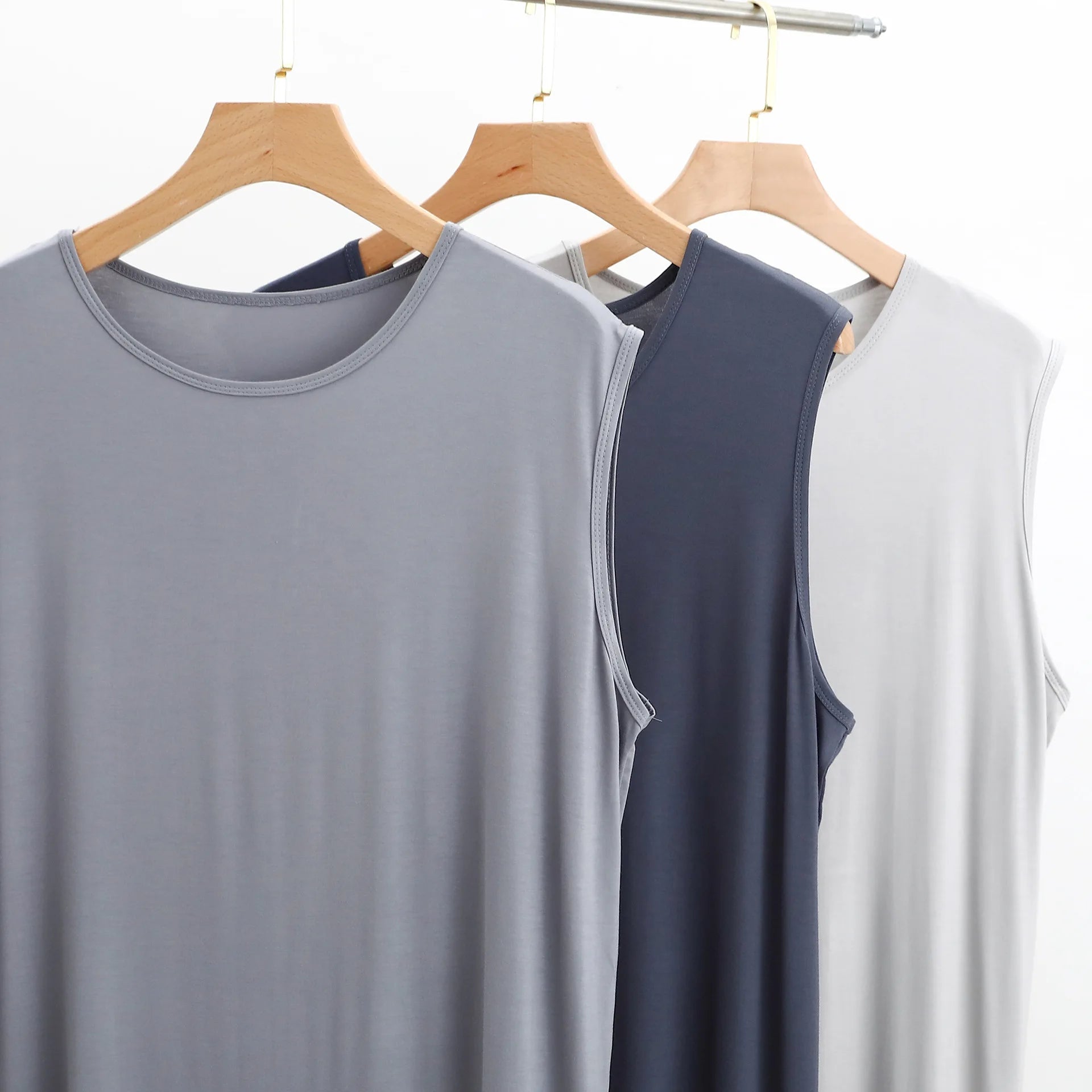 Neckline close-up: sleeveless sleepwear vest dress in gray, navy, and white
