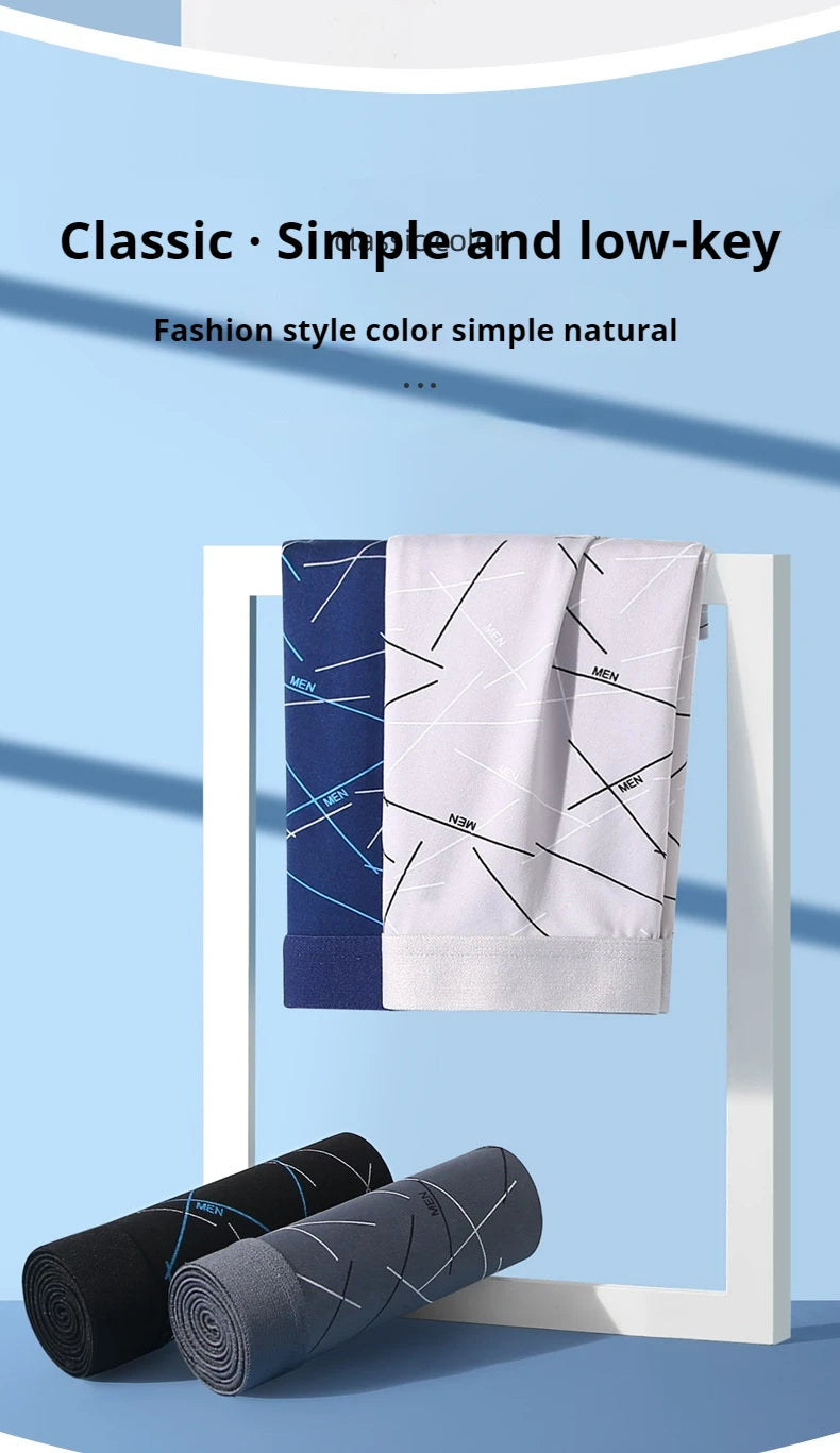Men’s stretch trunk shorts, folded with white, navy, and dark gray printed styles
