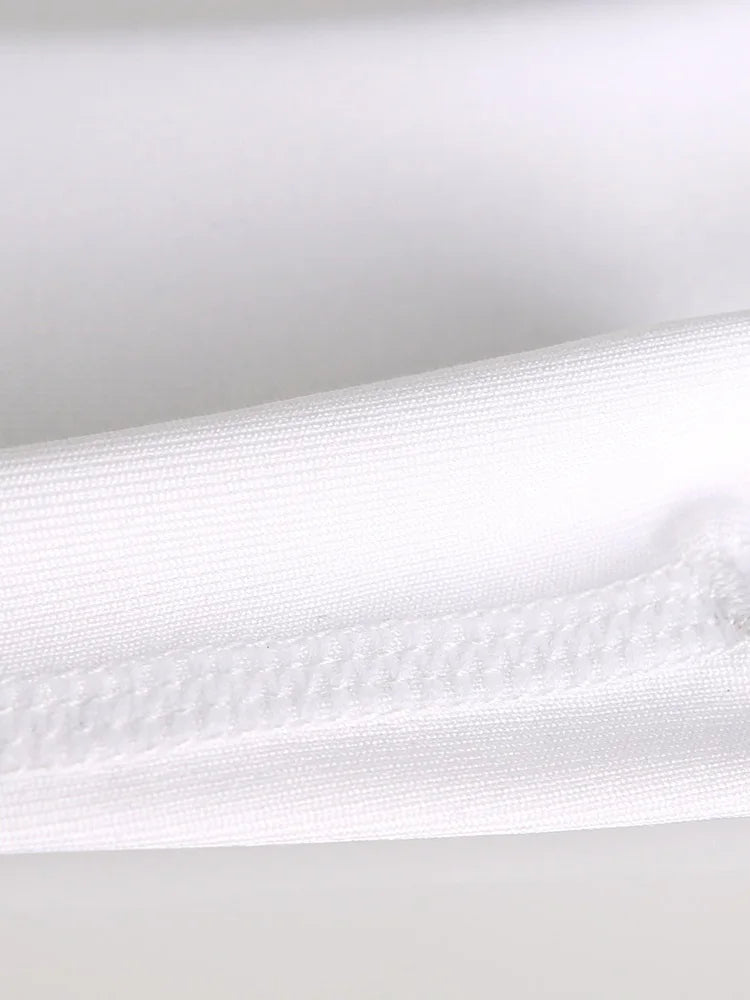 White seamless vest fabric close-up with textured knit finish