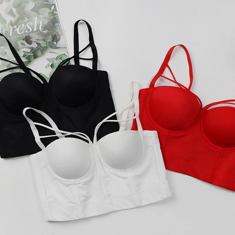 Assorted corset bustier bras in black, white, and red with underwire cups