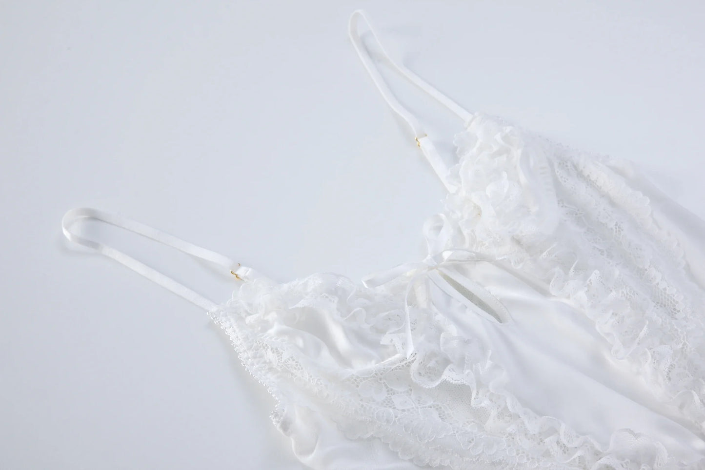 White lace babydoll bodysuit flat lay with tie-front and thin straps