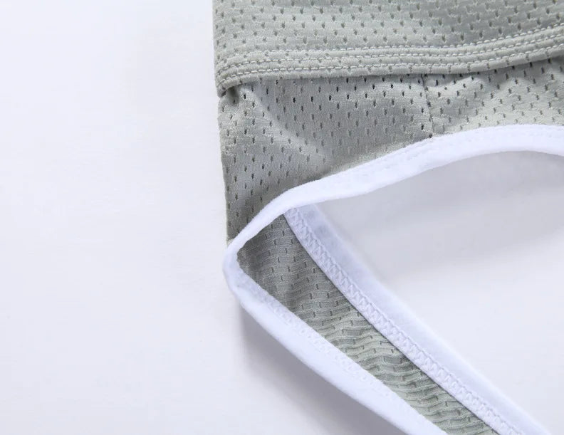 Low-rise hip-lift thong light gray leg opening with white edging and textured panel