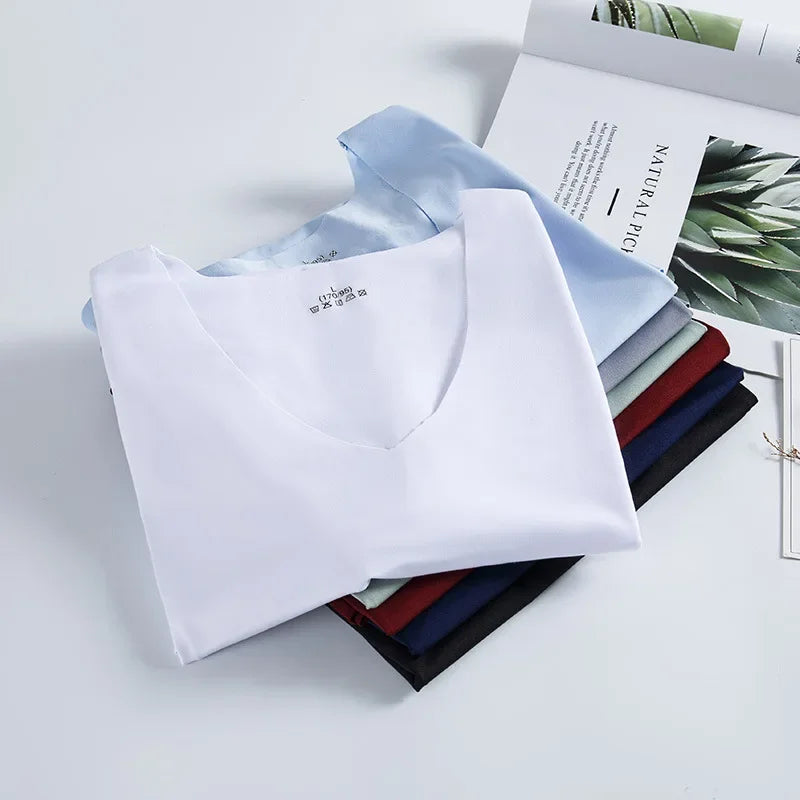 Folded men's V-neck sleeveless tank tops in white and blue tones