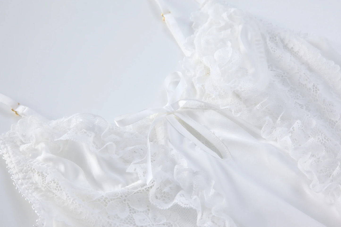 White lace backless babydoll bodysuit with ruffled tiered skirt and bow detail