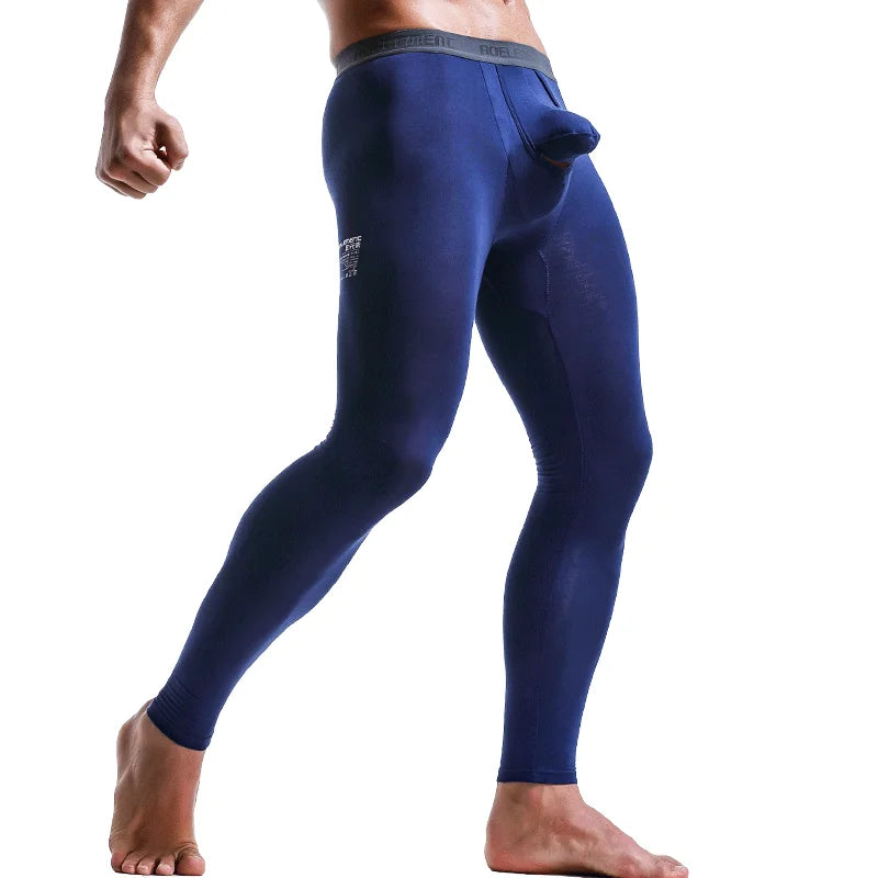 Blue thermal base layer pants shown on model, snug fit long sleeves at legs