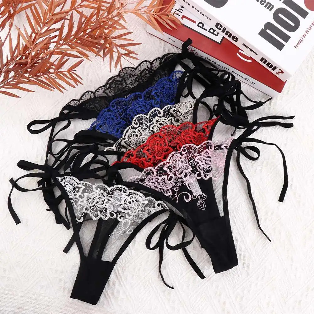 Assorted embroidered lace panty briefs with black bow ties in white, red, and blue