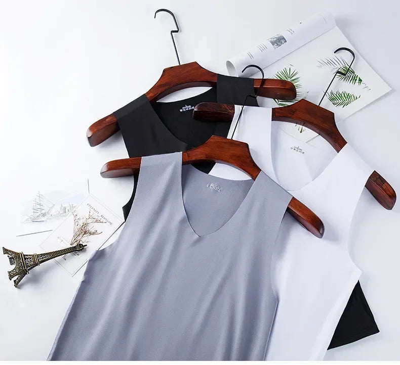 Men's V-neck tank tops in light blue, gray, white, and black on wooden hangers