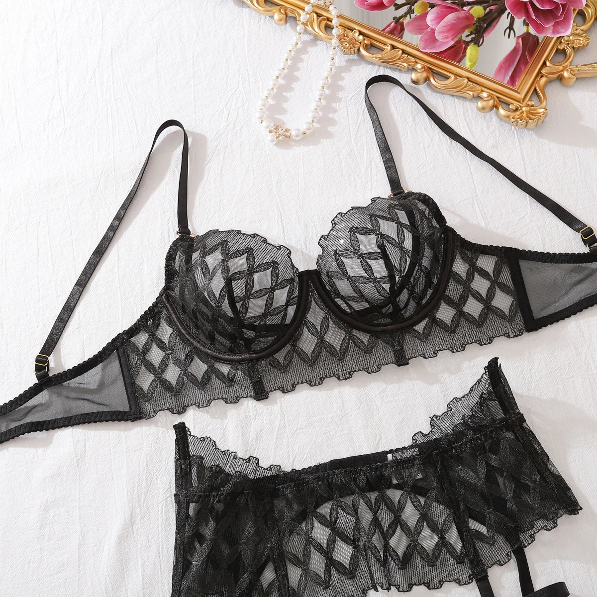 Black lace lingerie set flat lay: underwire bra and matching garter thong with straps
