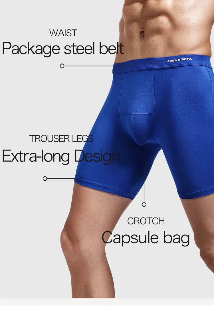Blue compression boxer briefs on model, mid-thigh length with elastic waistband