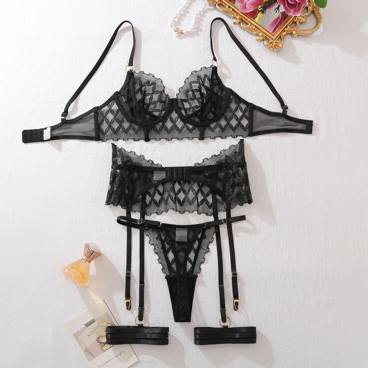 Black lace lingerie set: underwire bra, garter belt, and matching sheer panty
