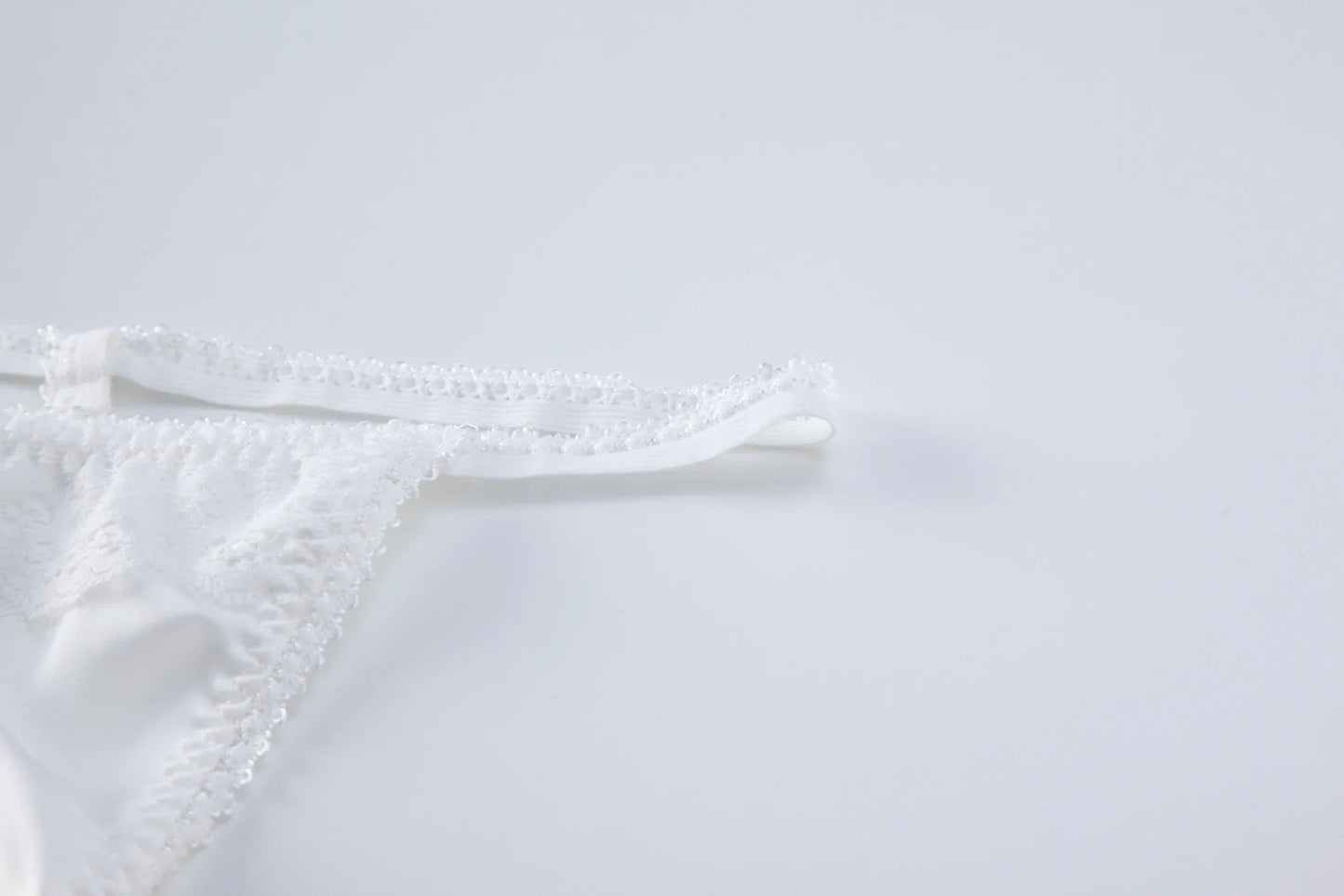 White lace backless bodysuit back straps and scalloped lace trim detail