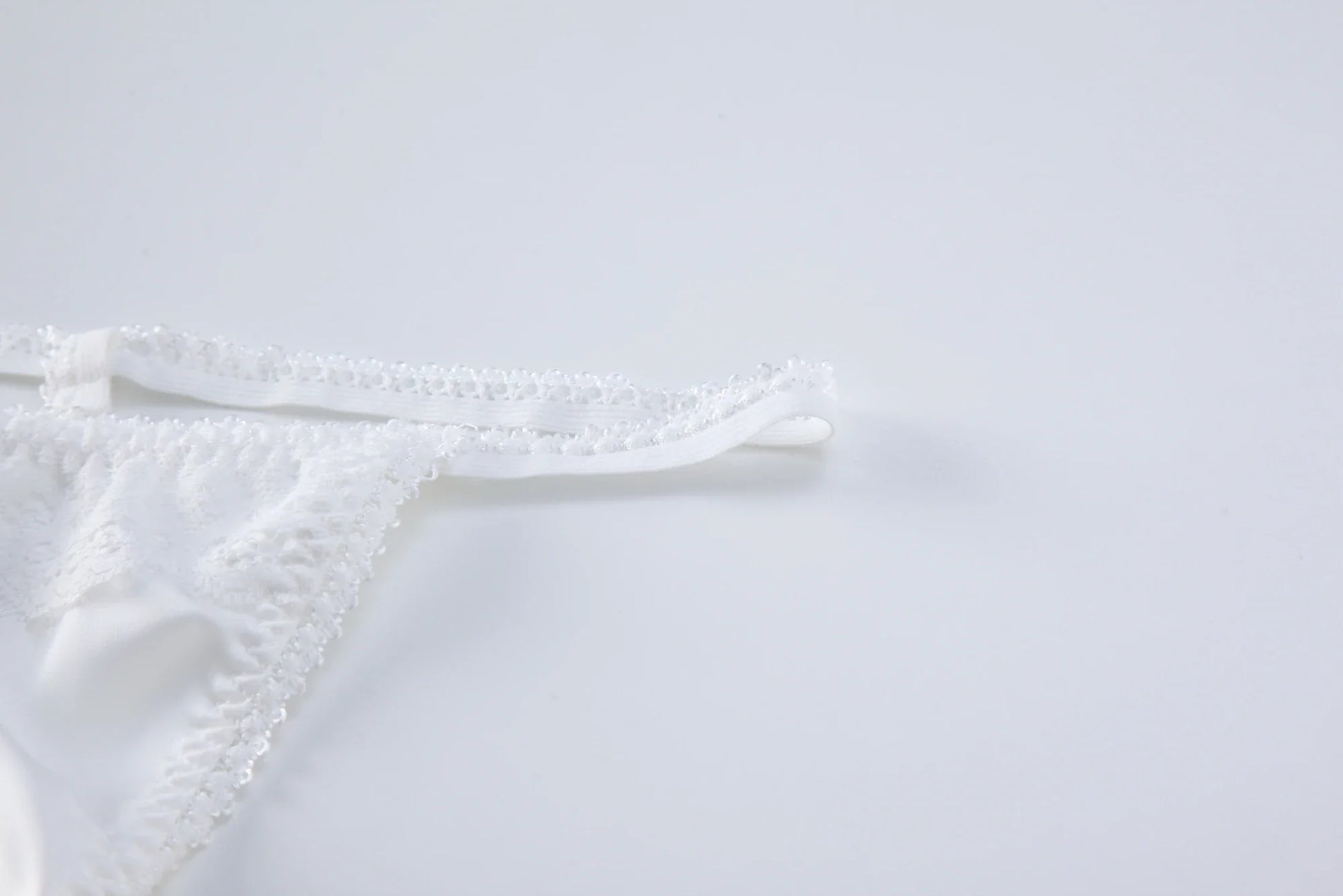 White lace backless bodysuit back straps and scalloped lace trim detail