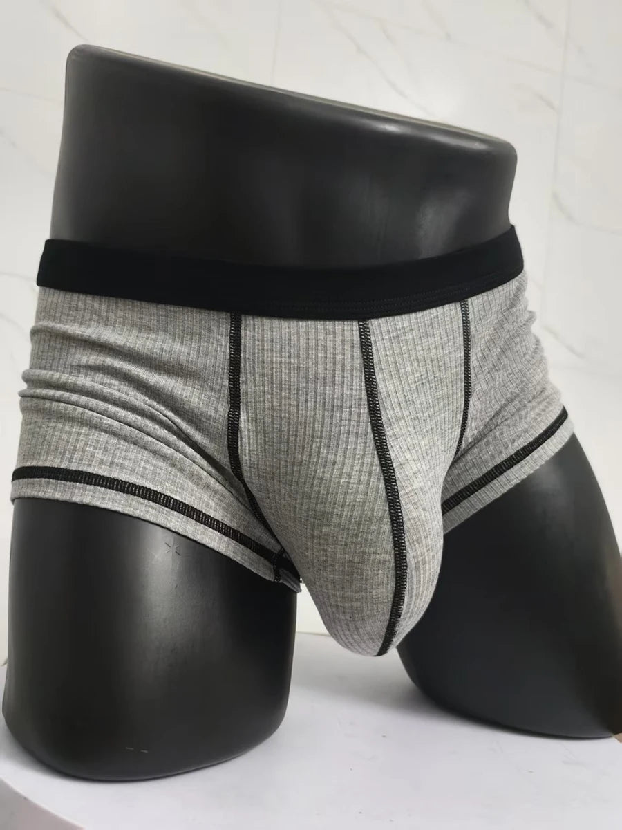 Gray ribbed boxer shorts with black waistband and contrast trim, front pouch seam.