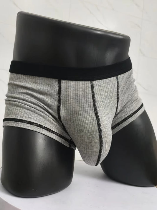 Gray ribbed boxer shorts with black waistband and contrast trim, front pouch seam.