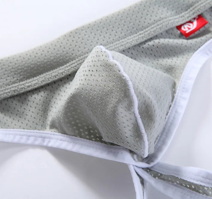 Low-rise hip-lift thong in light gray with white trim and textured fabric seam detail
