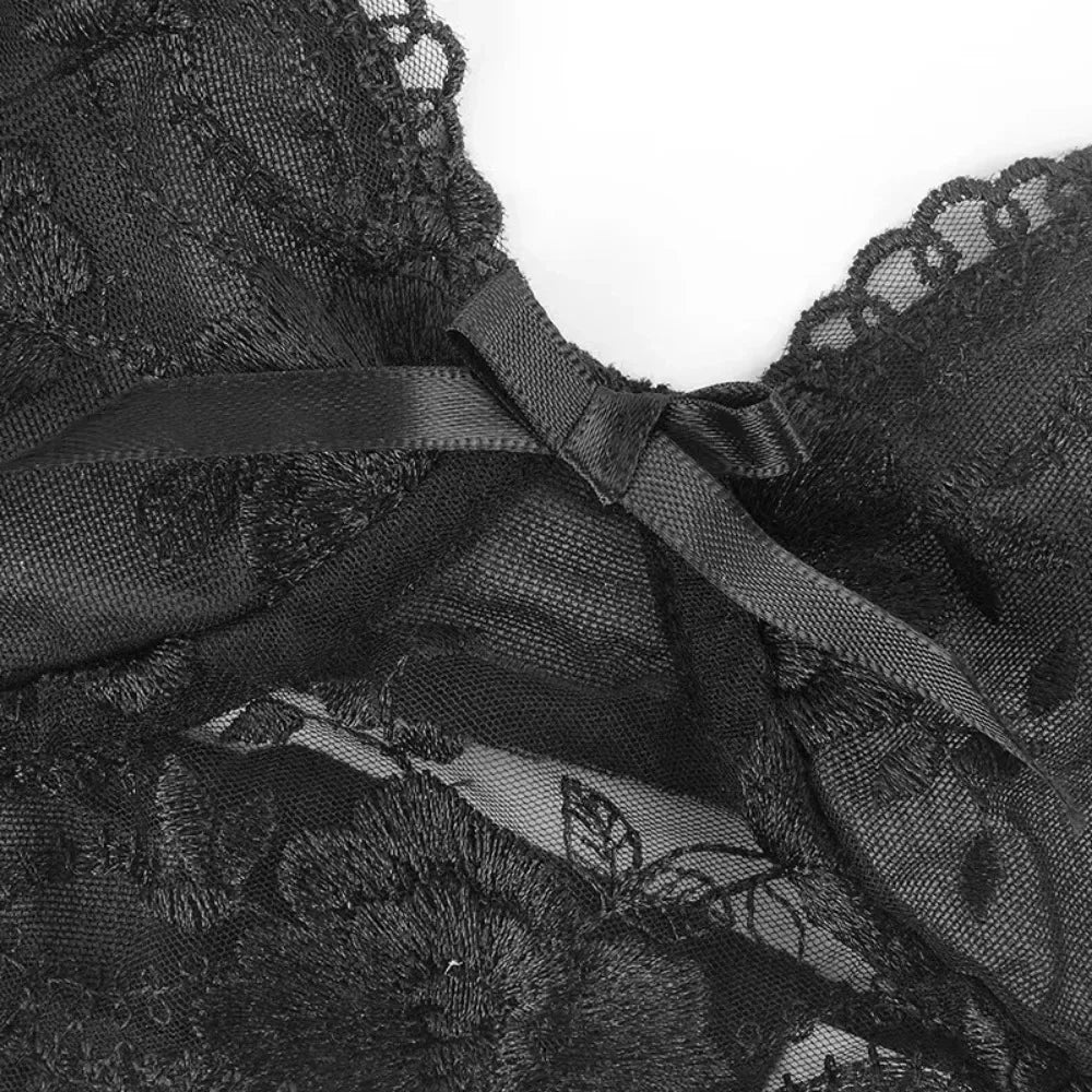 Black lace lingerie close-up with bow detail and scalloped mesh trim