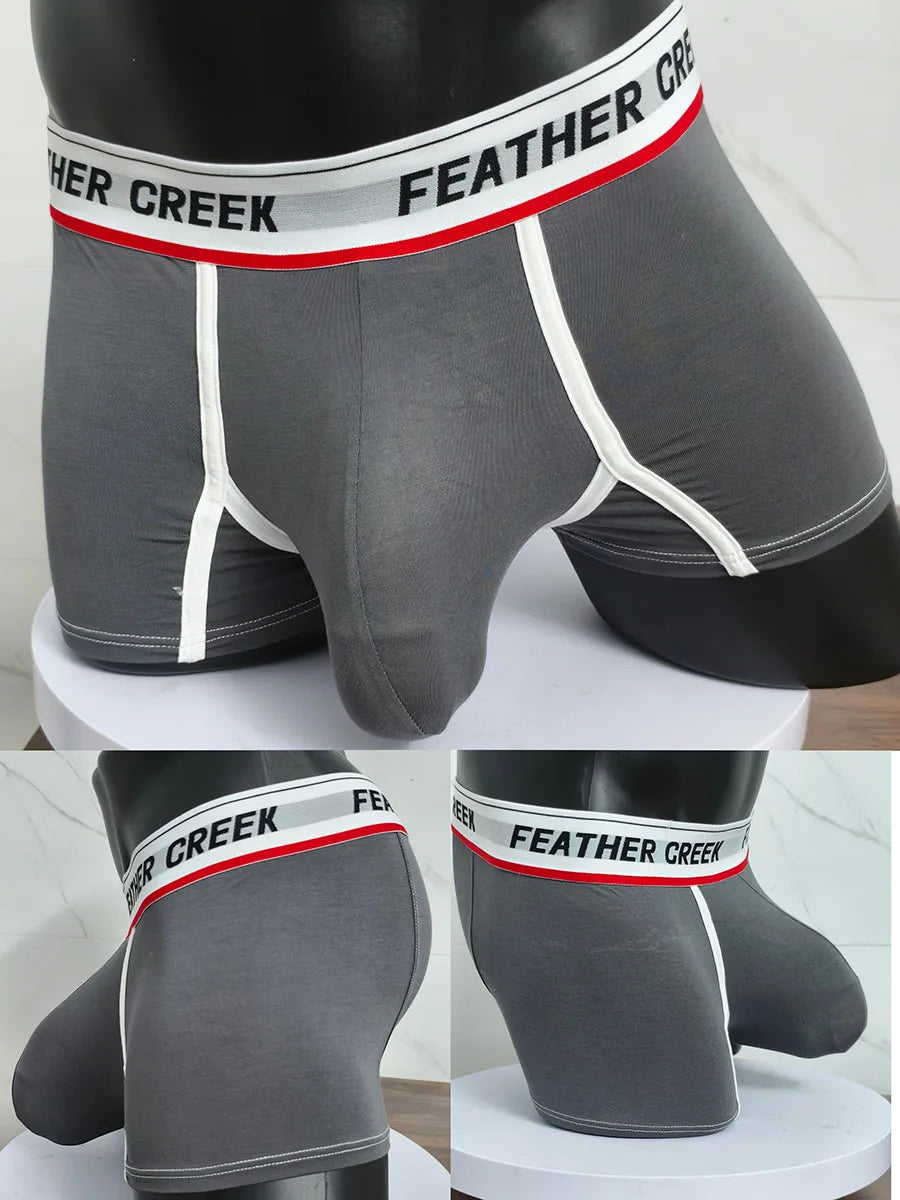 Dark gray sports boxer shorts with white contrast seams and contoured front pouch