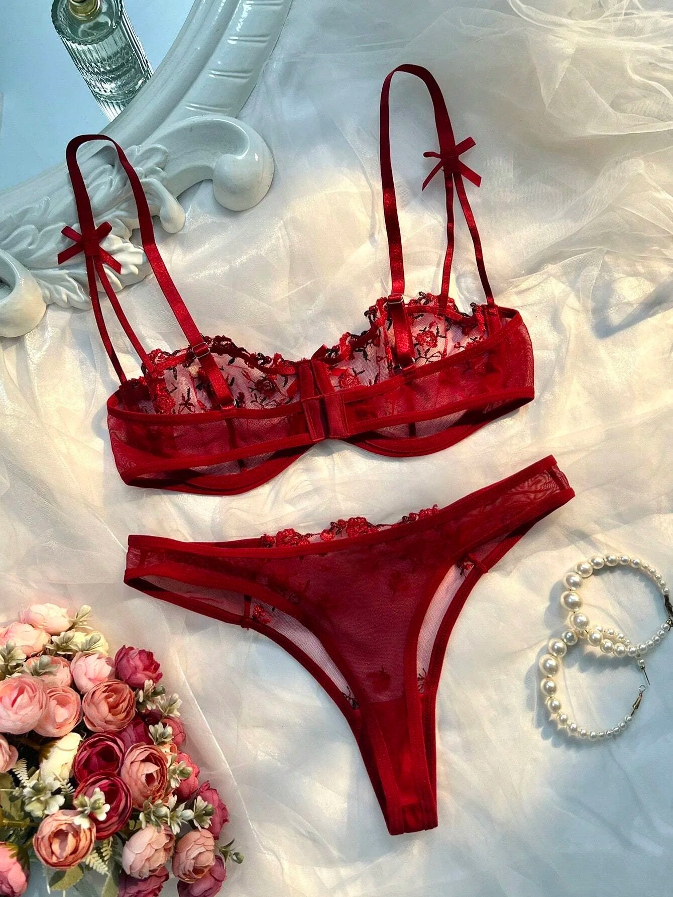 Red lace bra and thong set with sheer mesh and bow accents on straps