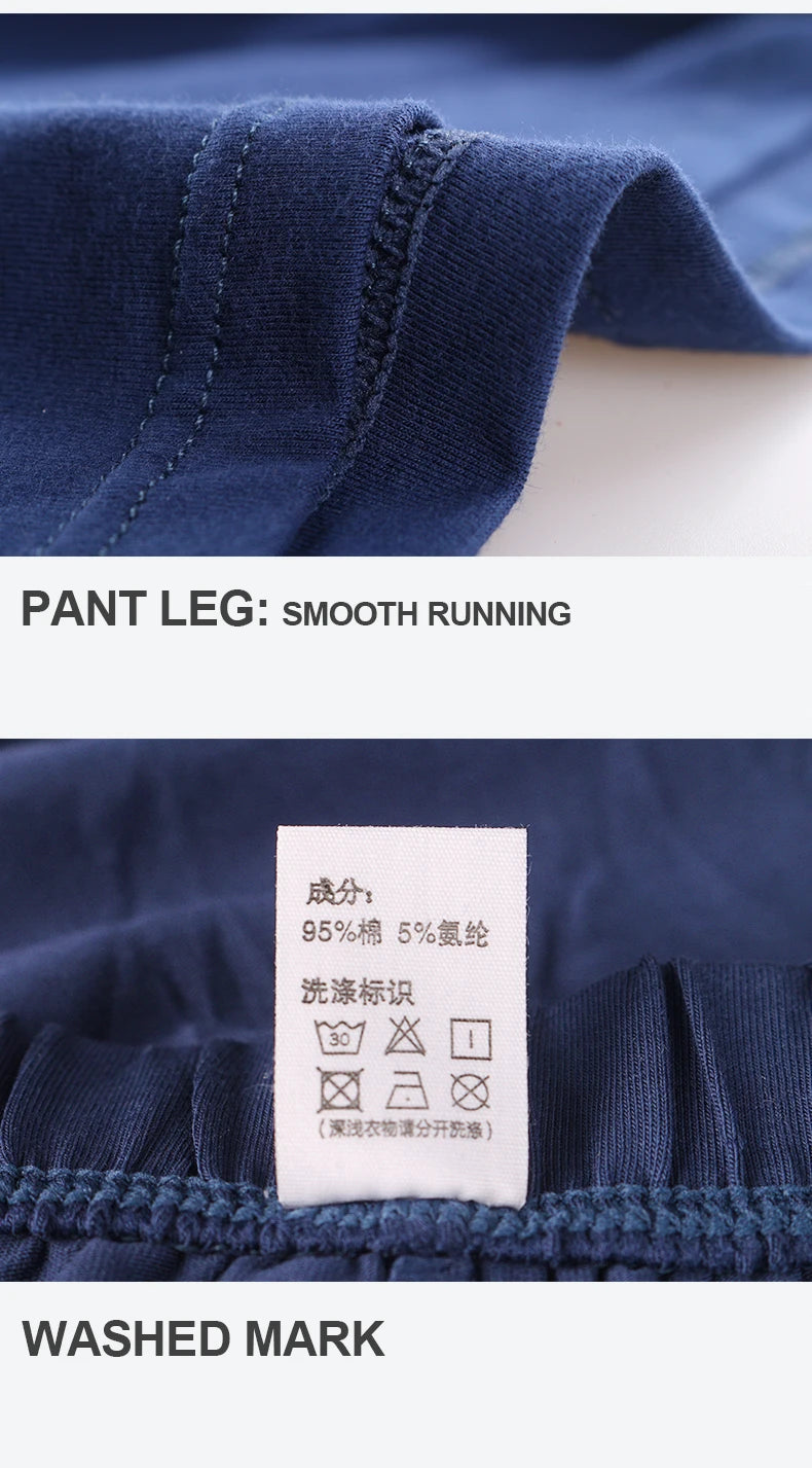 Navy cotton pyjama boxer shorts fabric close-up with stitched waistband and tag