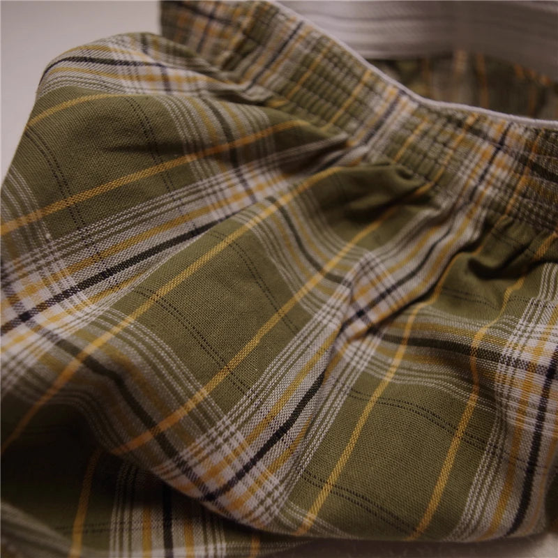 Olive plaid cotton boxer briefs fabric close-up with stitched waistband seam