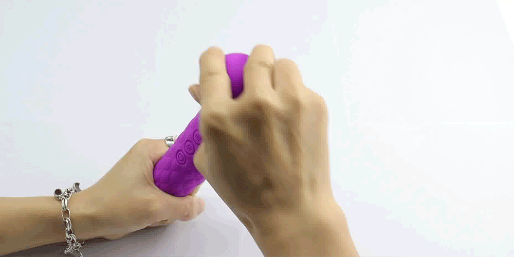 Purple g-spot magic wand vibrator with textured grip and control buttons, held in hand